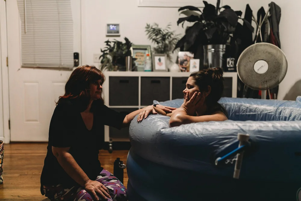 A midwife talking with a family