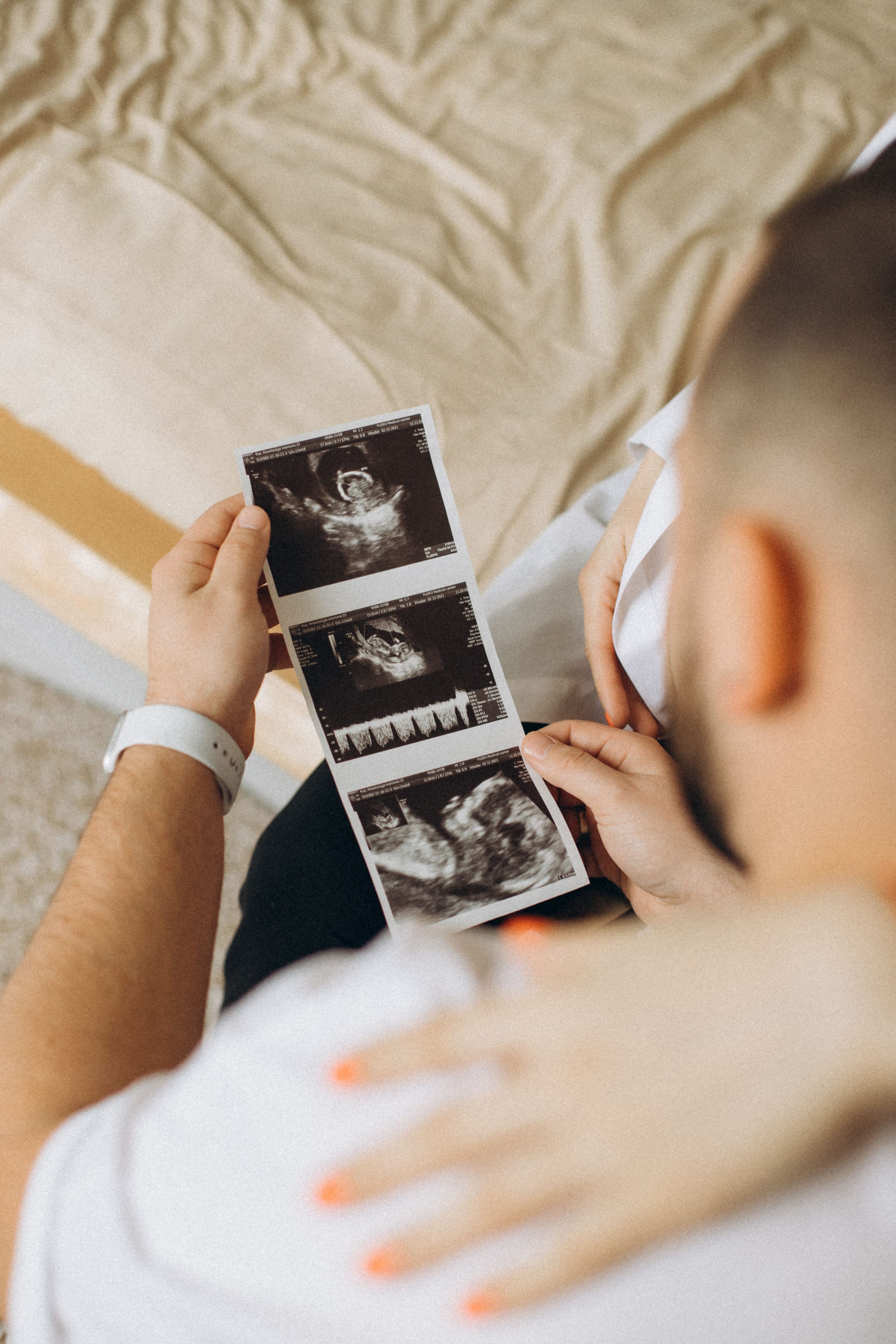 A couple looking at ultrasound photos together